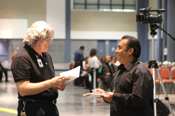 Two MTIS employees working at 2011 Fall Graduation